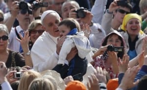 Pope greets baby as he arrives to lead general audience at Vatican