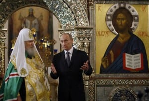 Russian President Putin speaks to Russian Orthodox Patriarch Alexiy II during visit to Iversky Monastery