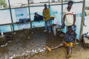Liberians wait outside Ebola treatment center